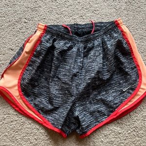 Black/gray Nike tempo shorts with orange piping
